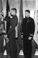 USMA Brigade Commander C. Robert Arvin exchanges flags with Marine Cadet, and two USNA Cadets. Need names here. USMA Library Dedication